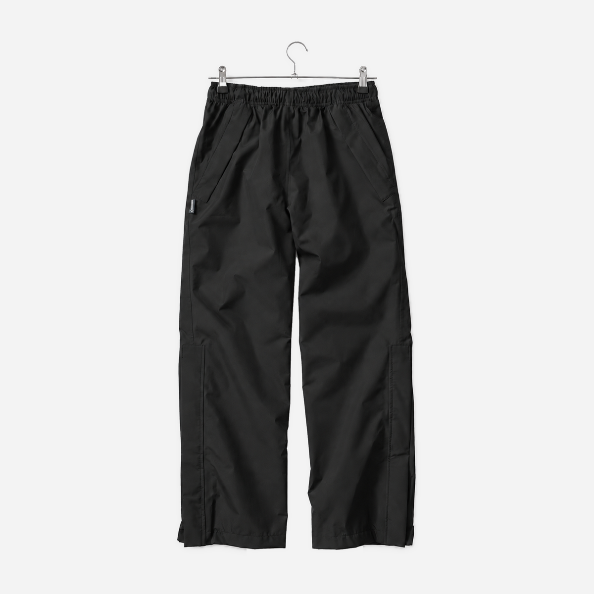 Boathouse Women's Waterproof Pants in Black, front view on a chrome hanger