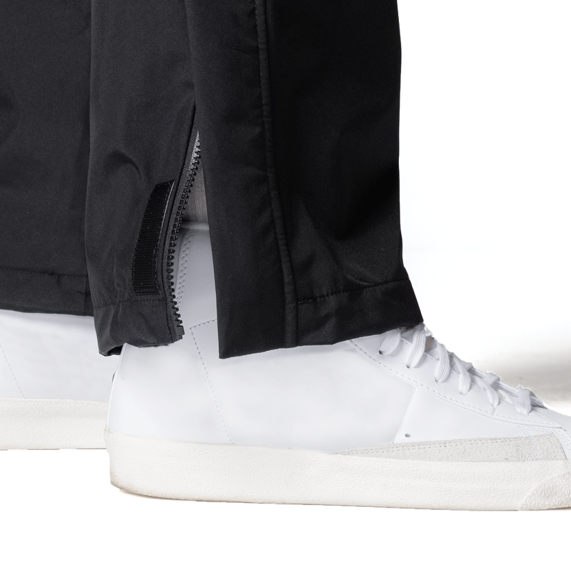 Boathouse Women's Waterproof Pants in Black, open ankle zipper above a white sneaker